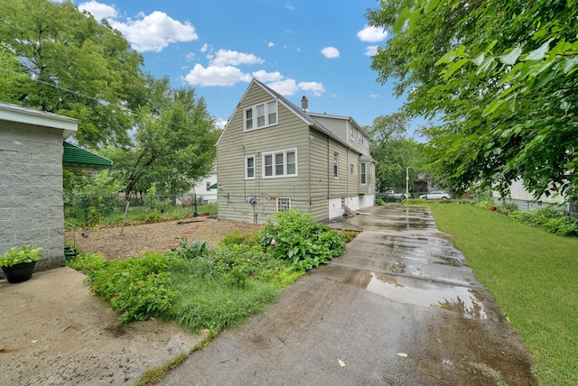 view of property exterior with a yard