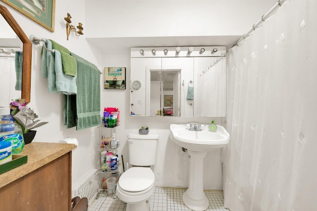 bathroom featuring toilet and tile patterned flooring