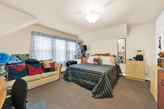 bedroom featuring dark colored carpet and lofted ceiling