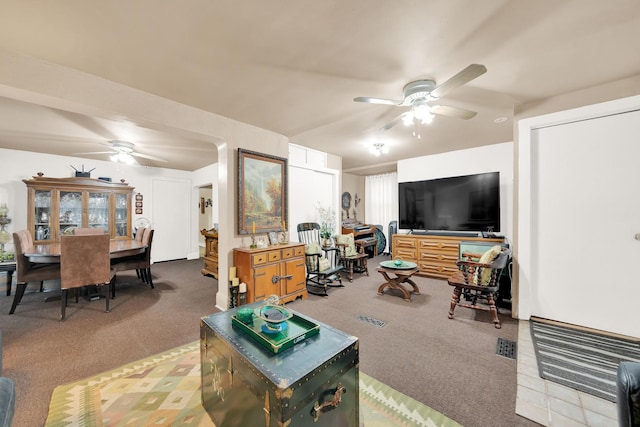 living room featuring ceiling fan and carpet