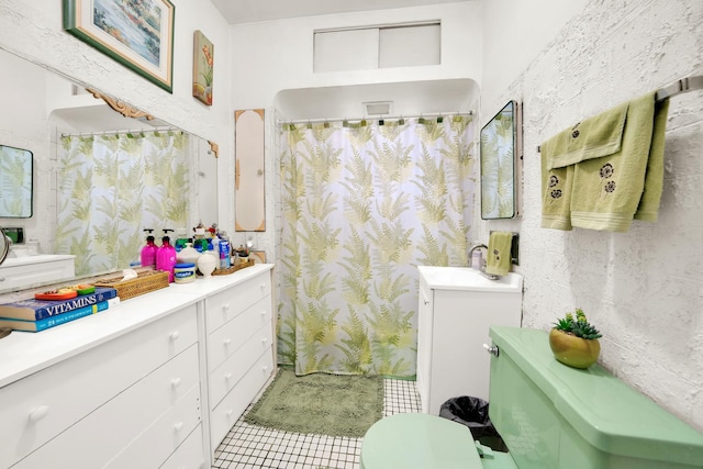 bathroom featuring vanity, toilet, and tile patterned floors