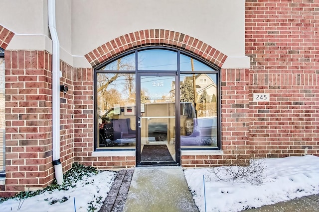 view of snow covered property entrance