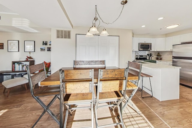 dining space featuring light wood-type flooring