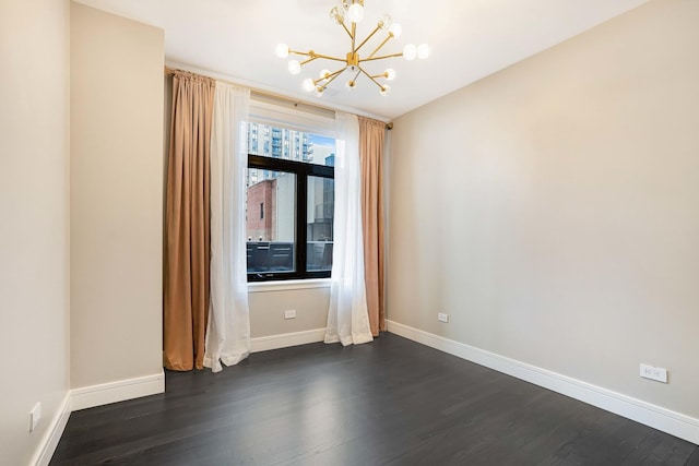 unfurnished room featuring a chandelier and dark hardwood / wood-style flooring