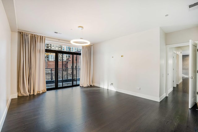 empty room with dark hardwood / wood-style floors