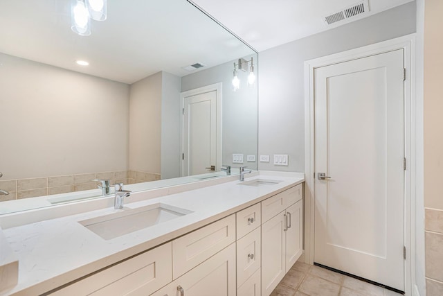 bathroom featuring tile patterned flooring and vanity