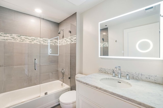 full bathroom with vanity, toilet, and enclosed tub / shower combo