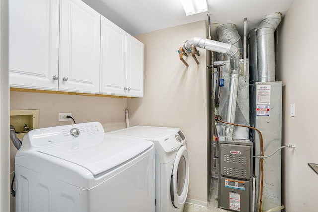 laundry area with washer and dryer and cabinets