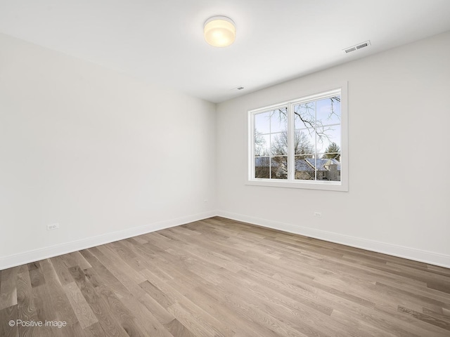 spare room featuring light wood-type flooring