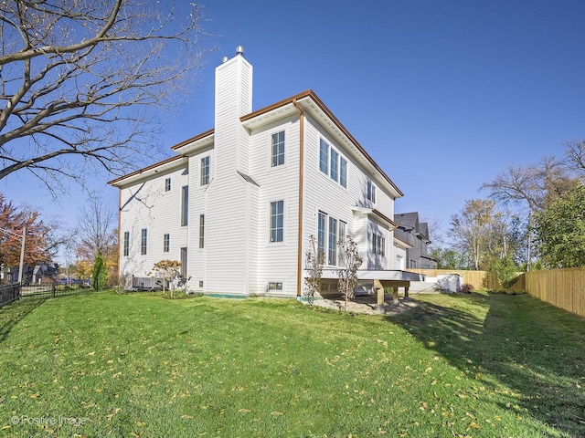 rear view of property with a lawn