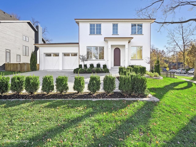 view of front of property with a garage and a front lawn