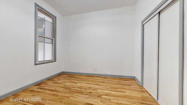 unfurnished bedroom with a closet and light hardwood / wood-style floors