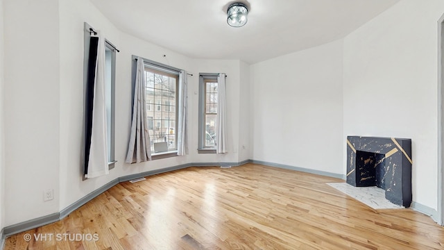 unfurnished living room with wood-type flooring