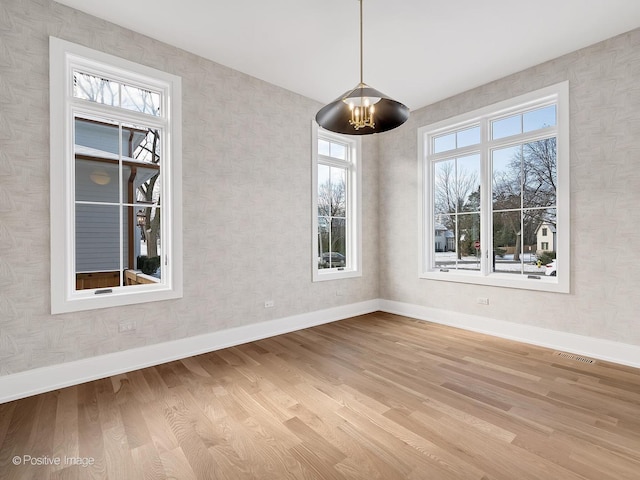 unfurnished dining area with light hardwood / wood-style floors