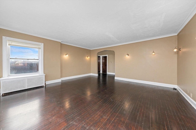 unfurnished room featuring wood-type flooring, radiator, and ornamental molding