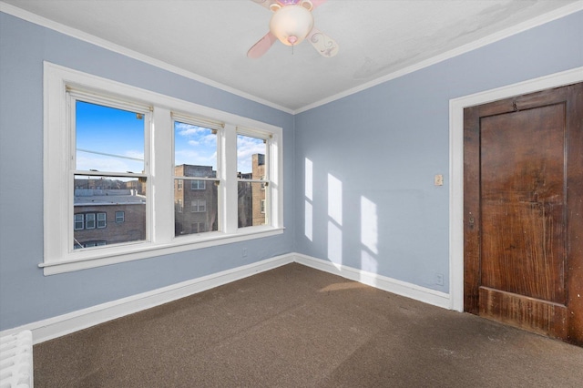 carpeted empty room with ceiling fan and ornamental molding