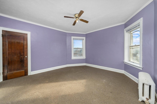 carpeted empty room featuring ceiling fan, radiator heating unit, and crown molding