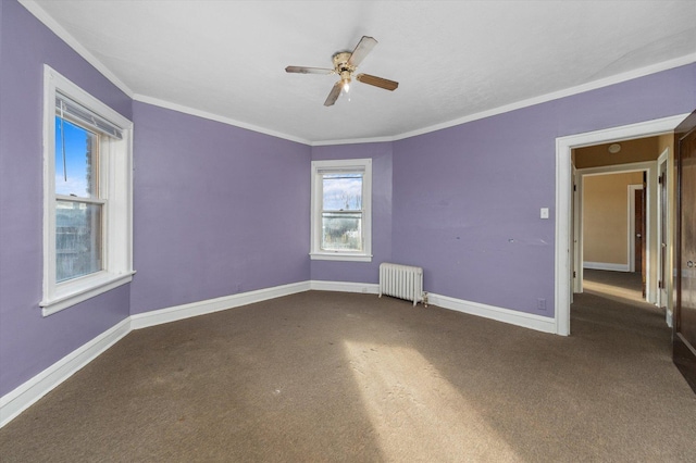 unfurnished room featuring radiator heating unit, carpet floors, ceiling fan, and ornamental molding