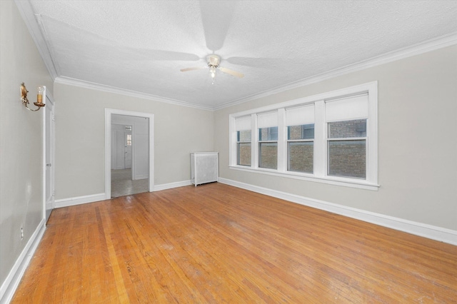 spare room featuring ceiling fan, crown molding, a textured ceiling, and hardwood / wood-style floors