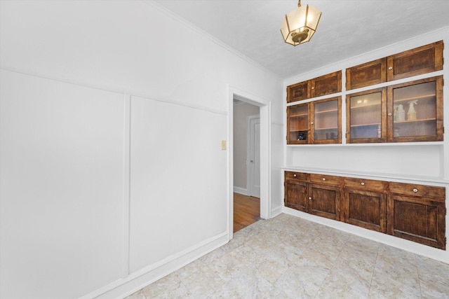 unfurnished dining area with ornamental molding