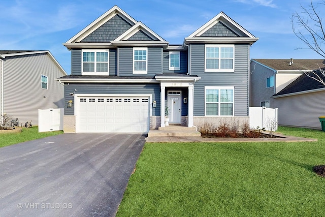 view of front of property with a front yard and a garage