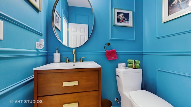 bathroom featuring vanity and toilet