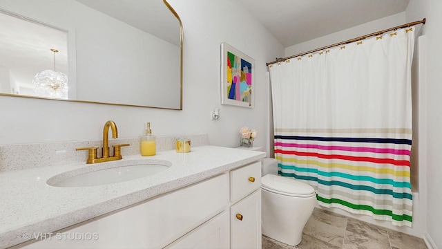 bathroom featuring vanity, a chandelier, and toilet