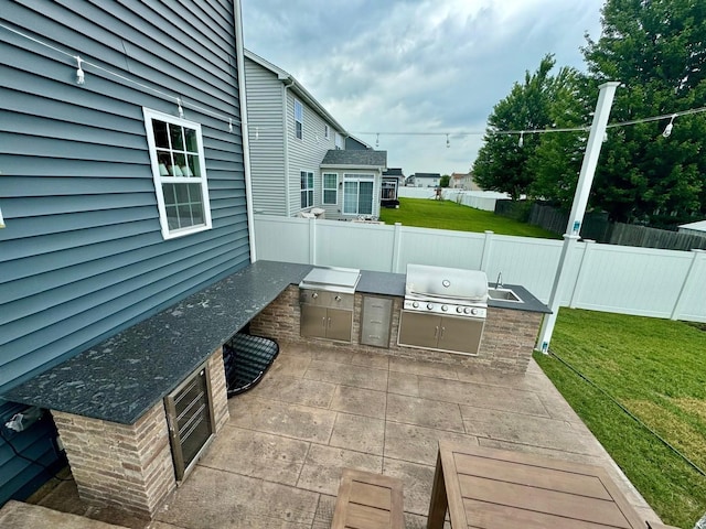 view of patio / terrace featuring sink, a grill, and exterior kitchen