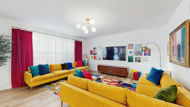 living room with a chandelier and wood-type flooring