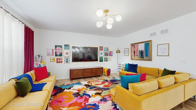 living room with wood-type flooring and a notable chandelier