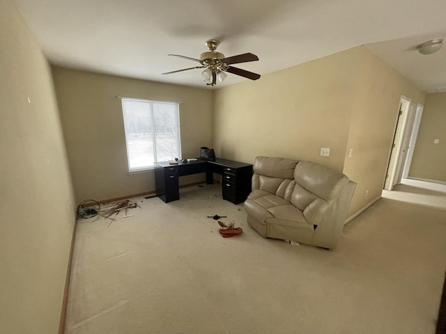 living area featuring carpet and ceiling fan