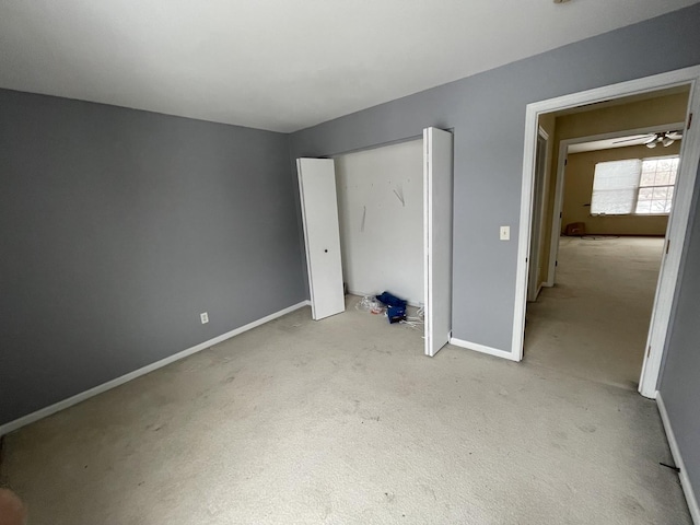 unfurnished bedroom with light colored carpet and a closet