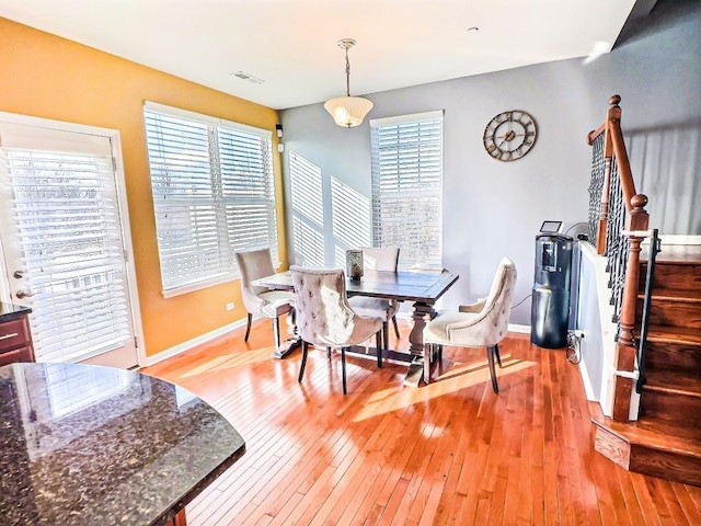 dining room featuring a wealth of natural light and light wood-type flooring