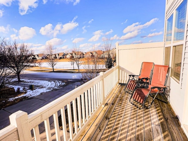 view of snow covered back of property