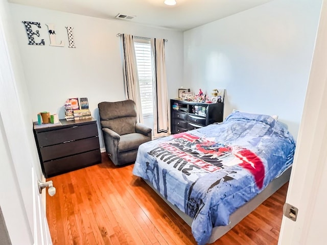 bedroom with hardwood / wood-style floors