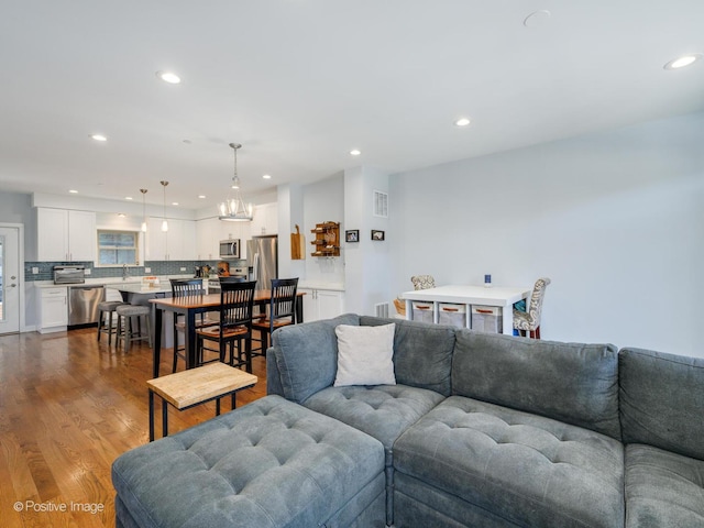 living room featuring sink and hardwood / wood-style floors