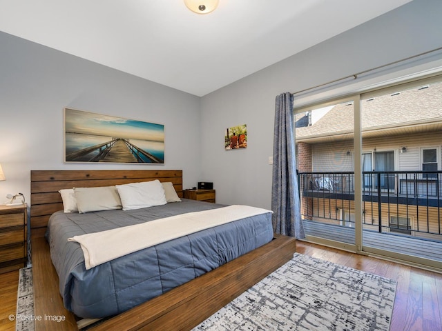 bedroom with wood-type flooring and access to outside