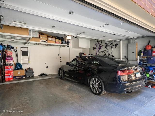 garage with a garage door opener and electric panel