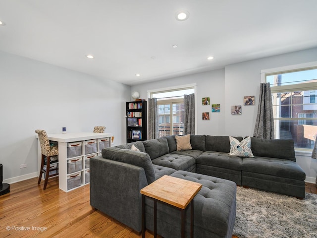 living room featuring plenty of natural light and light hardwood / wood-style floors