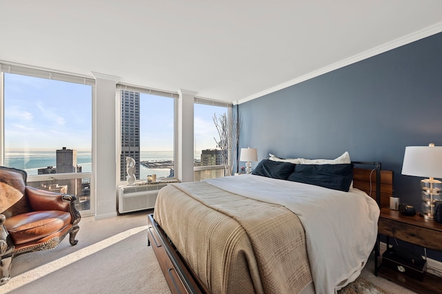 bedroom with crown molding, a water view, carpet, and a wall of windows