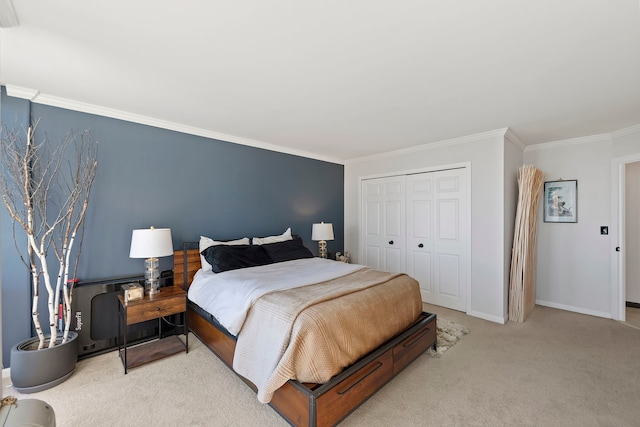 carpeted bedroom featuring ornamental molding and a closet