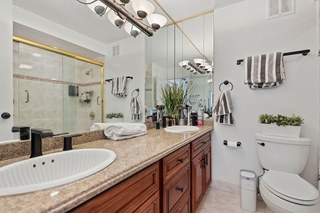 bathroom featuring vanity, toilet, a shower with shower door, and tile patterned flooring