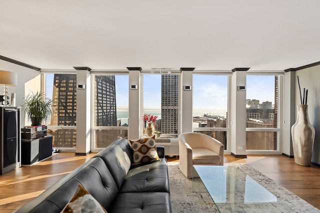 living room featuring a water view, ornamental molding, and hardwood / wood-style floors