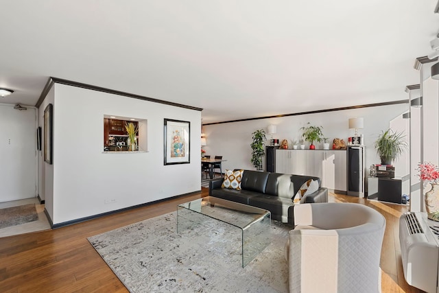 living room with ornamental molding and hardwood / wood-style floors