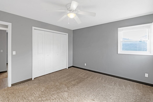 unfurnished bedroom featuring carpet floors, a closet, and ceiling fan