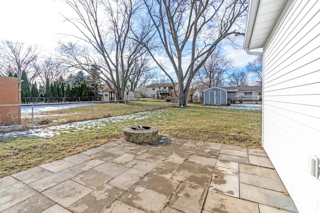 view of patio / terrace featuring a shed and a fire pit