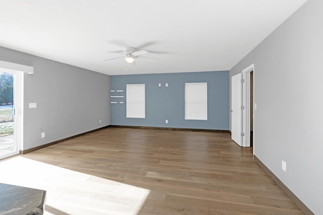 unfurnished room with hardwood / wood-style flooring and ceiling fan