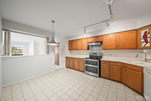 kitchen with sink, decorative light fixtures, double oven range, white dishwasher, and backsplash