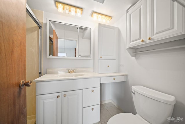 bathroom featuring vanity, tile patterned floors, and toilet