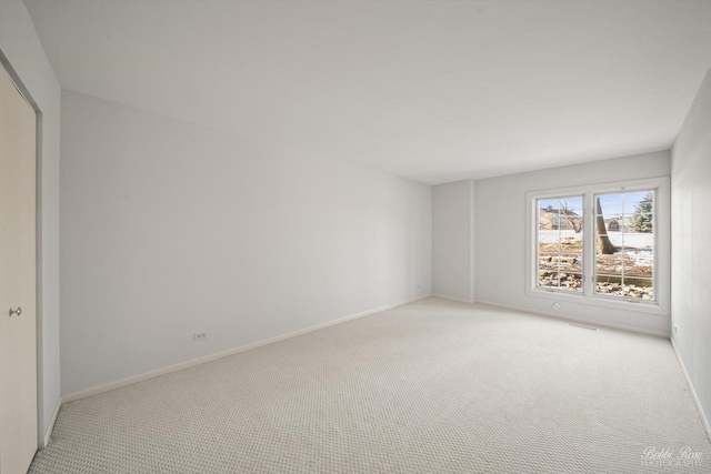 unfurnished bedroom with a closet and light carpet